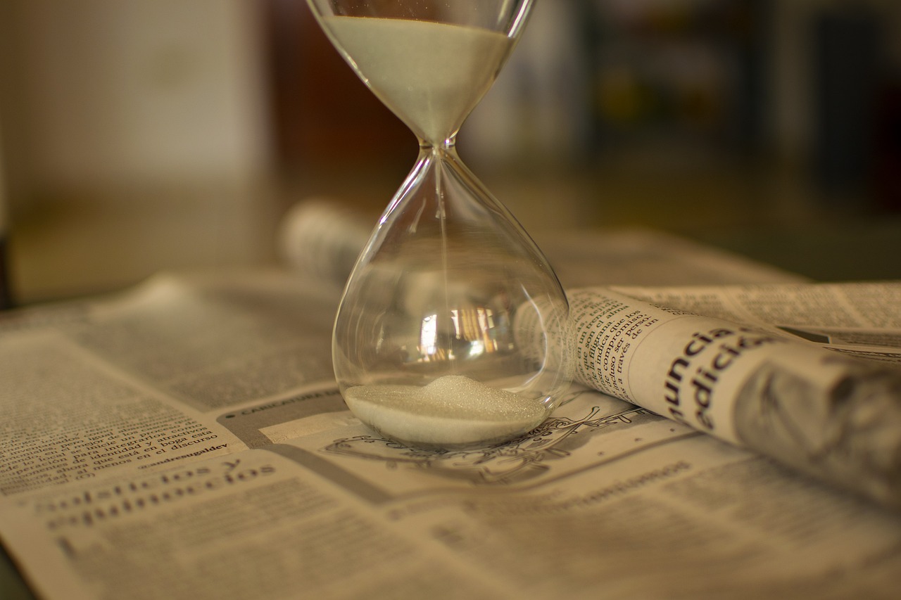 An hourglass with sand flowing through it, symbolizing legal time limits.