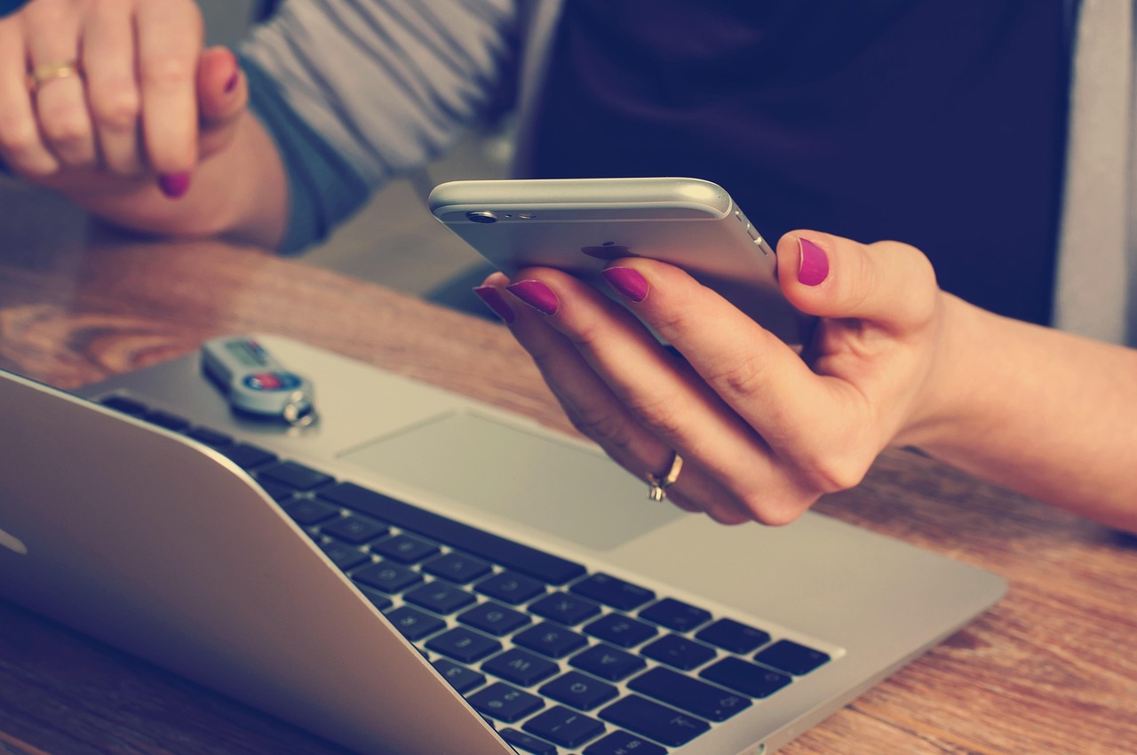 A person using a smartphone with a credit card nearby, representing a call to the bank issuer.