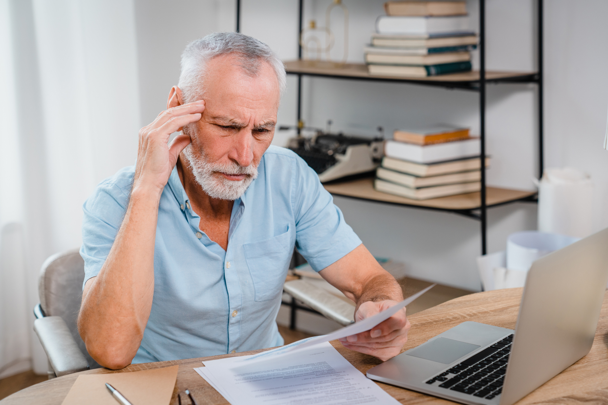 A senior man looking thoughtful while planning financial decisions.