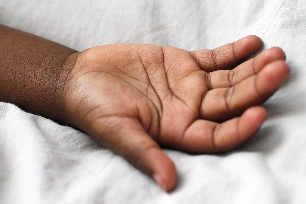 An elderly person and a child holding hands, symbolizing the transfer of assets across generations.