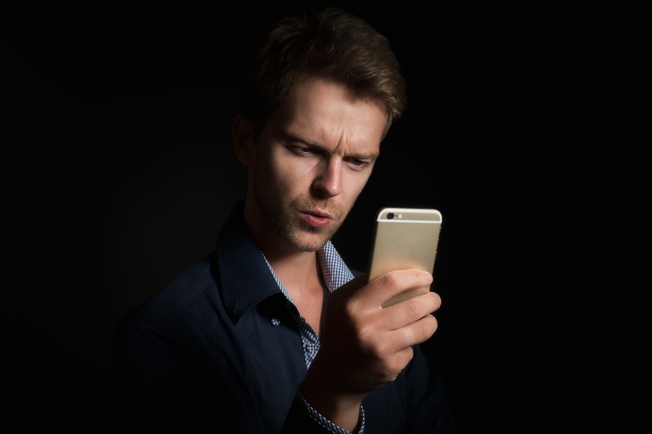 Close up hands navigating security and linked app settings on a mobile device.
