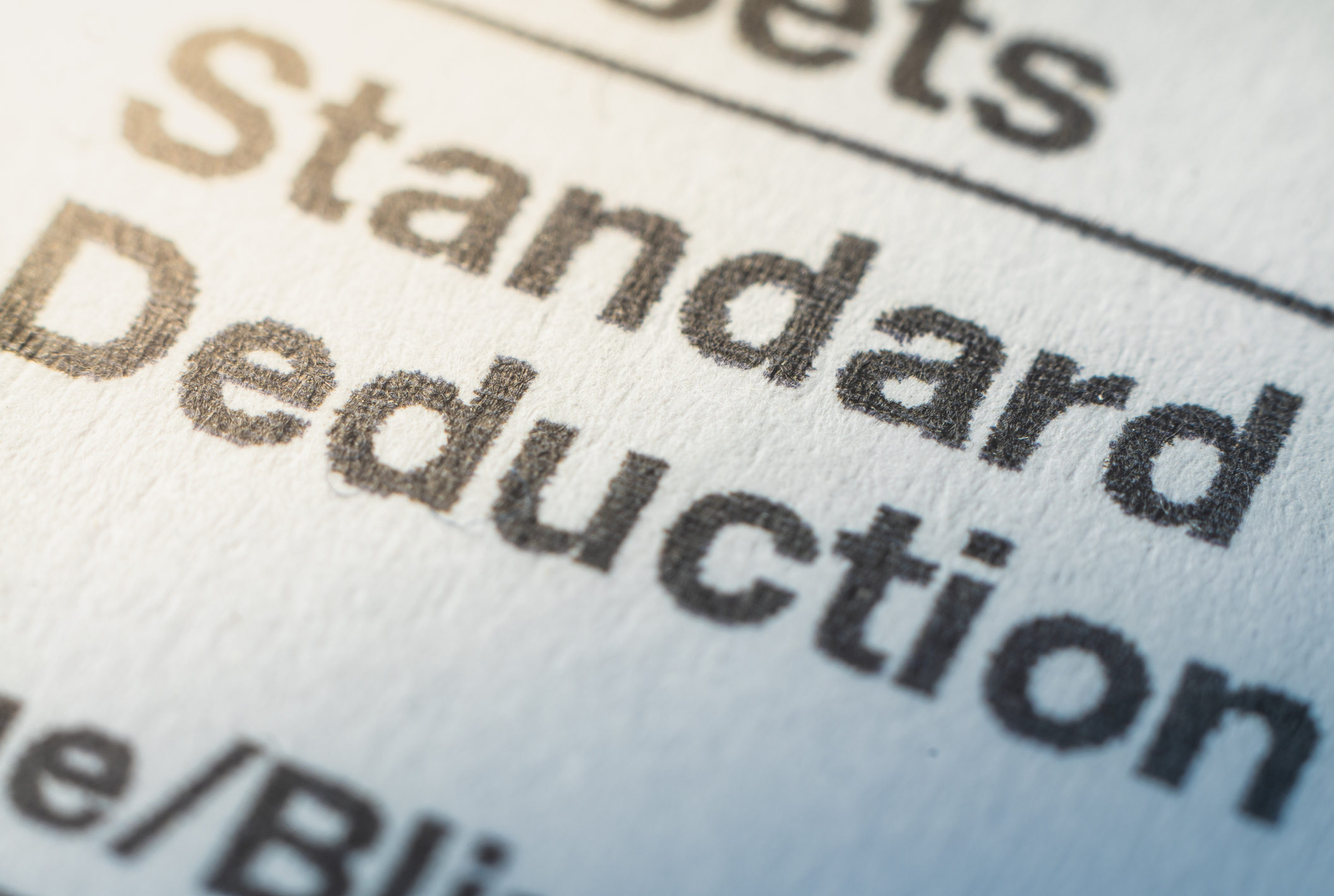 The words 'standard deduction' printed clearly on a white sheet of paper.
