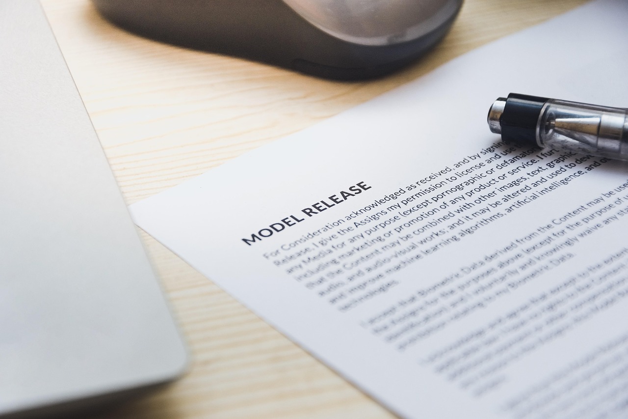 A close-up of a pen laying on a loan agreement document focusing on the terms and conditions section.