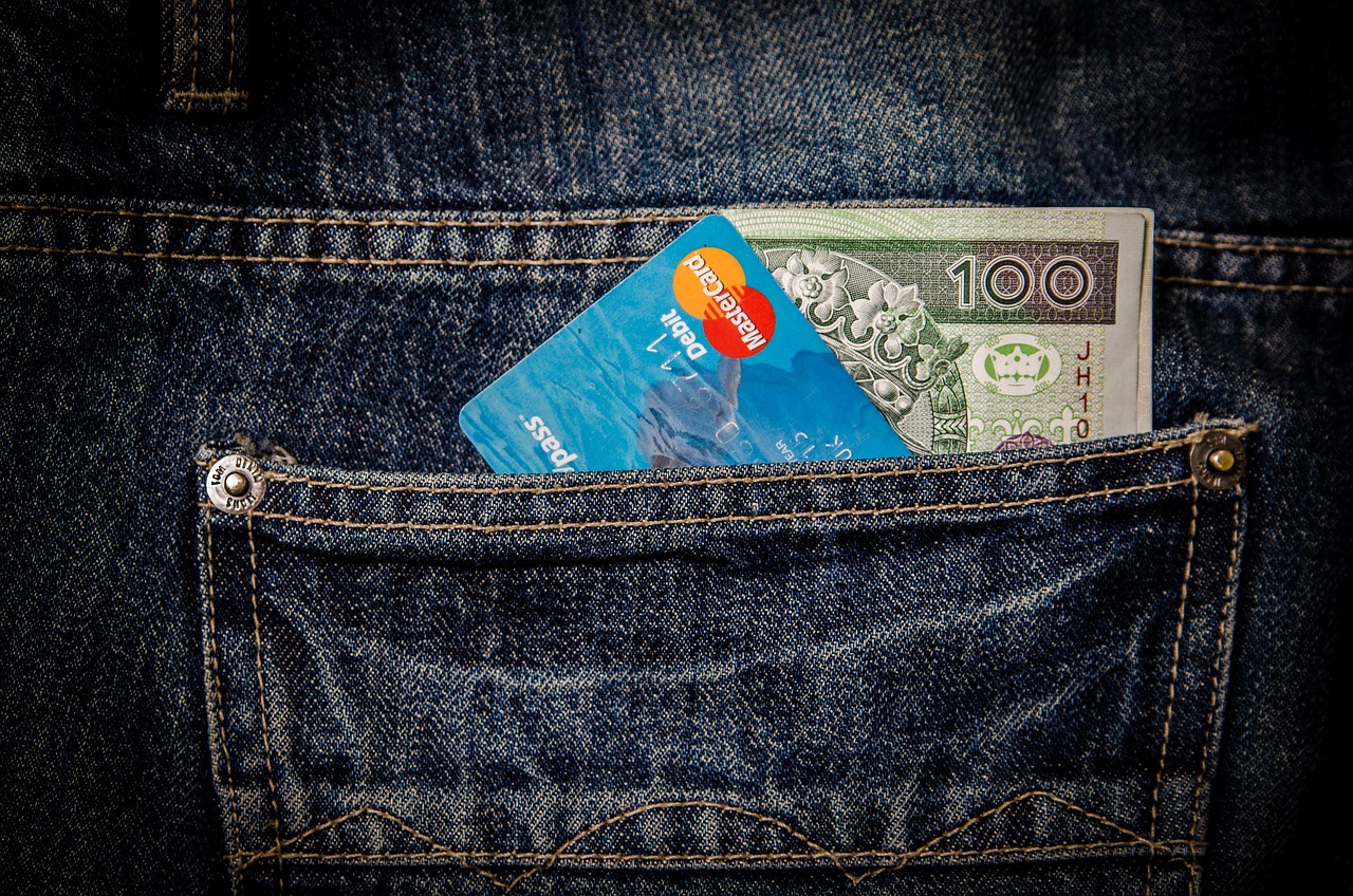 Close up of a credit card being used for a transaction to demonstrate utilization.