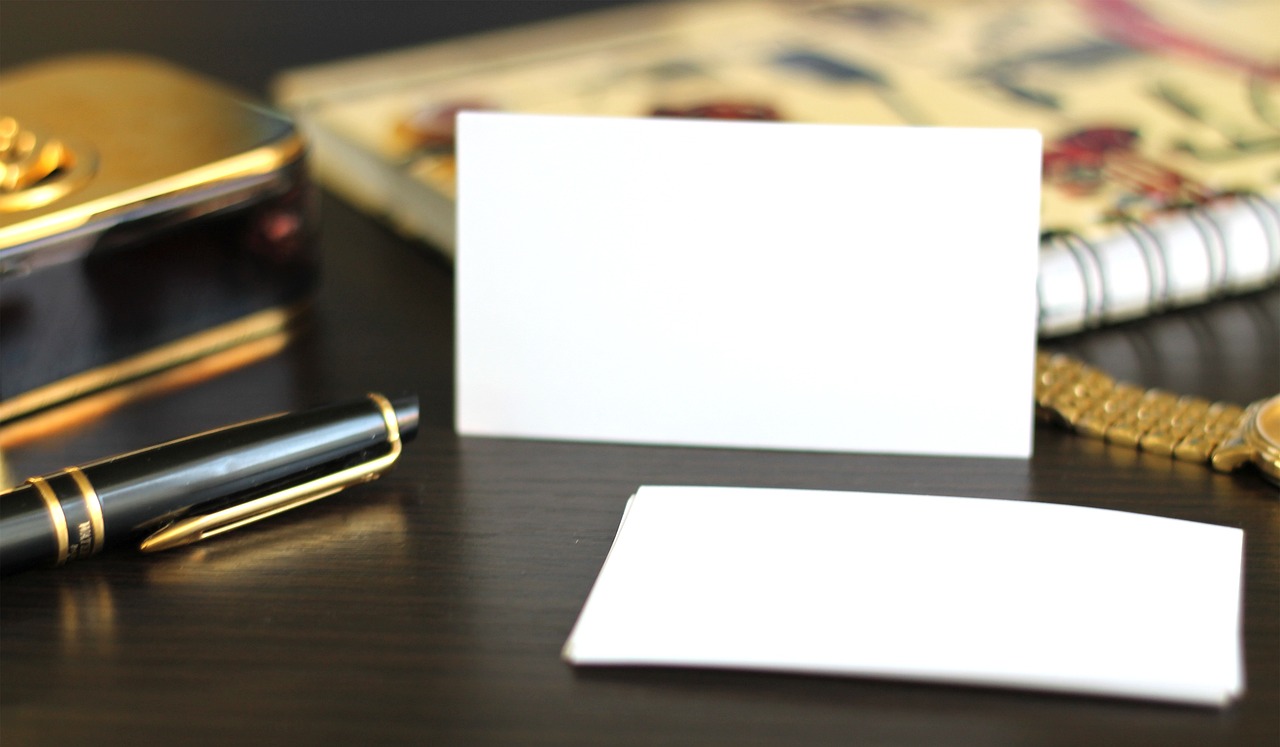 A luxury fountain pen on a leather notebook with a calculator