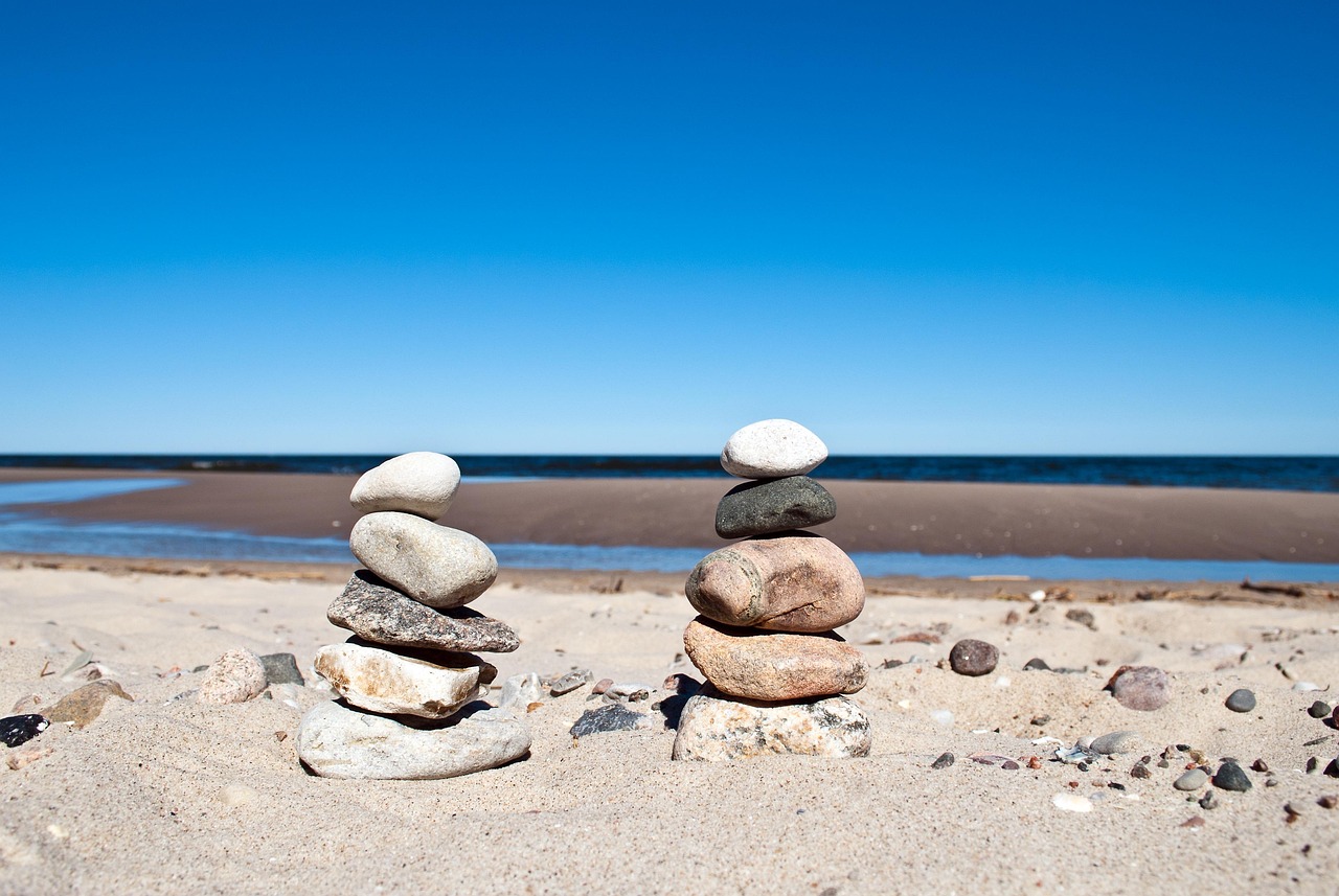 Stacked smooth stones in water, representing balance and simplicity in finance.