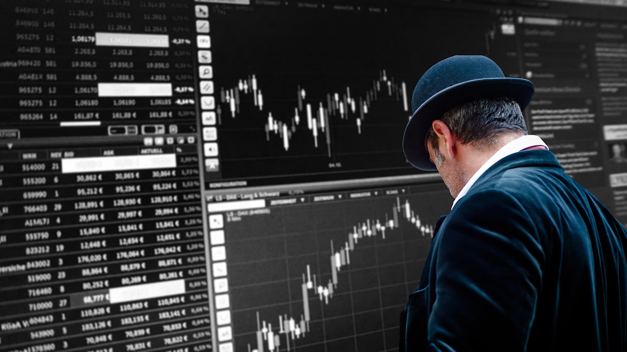 Laptop showing stock market data in a modern office with a city view
