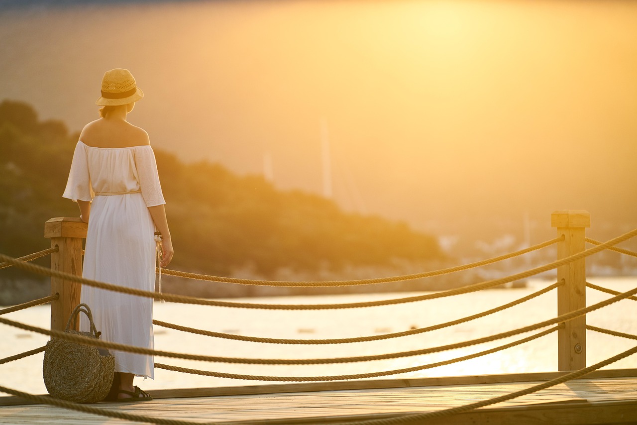 An individual sitting peacefully by a serene outdoor spot, representing the stress-free life that comes with financial organization.