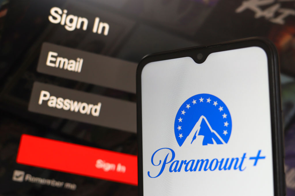 The Paramount+ app logo displayed on a smartphone held in a hand.