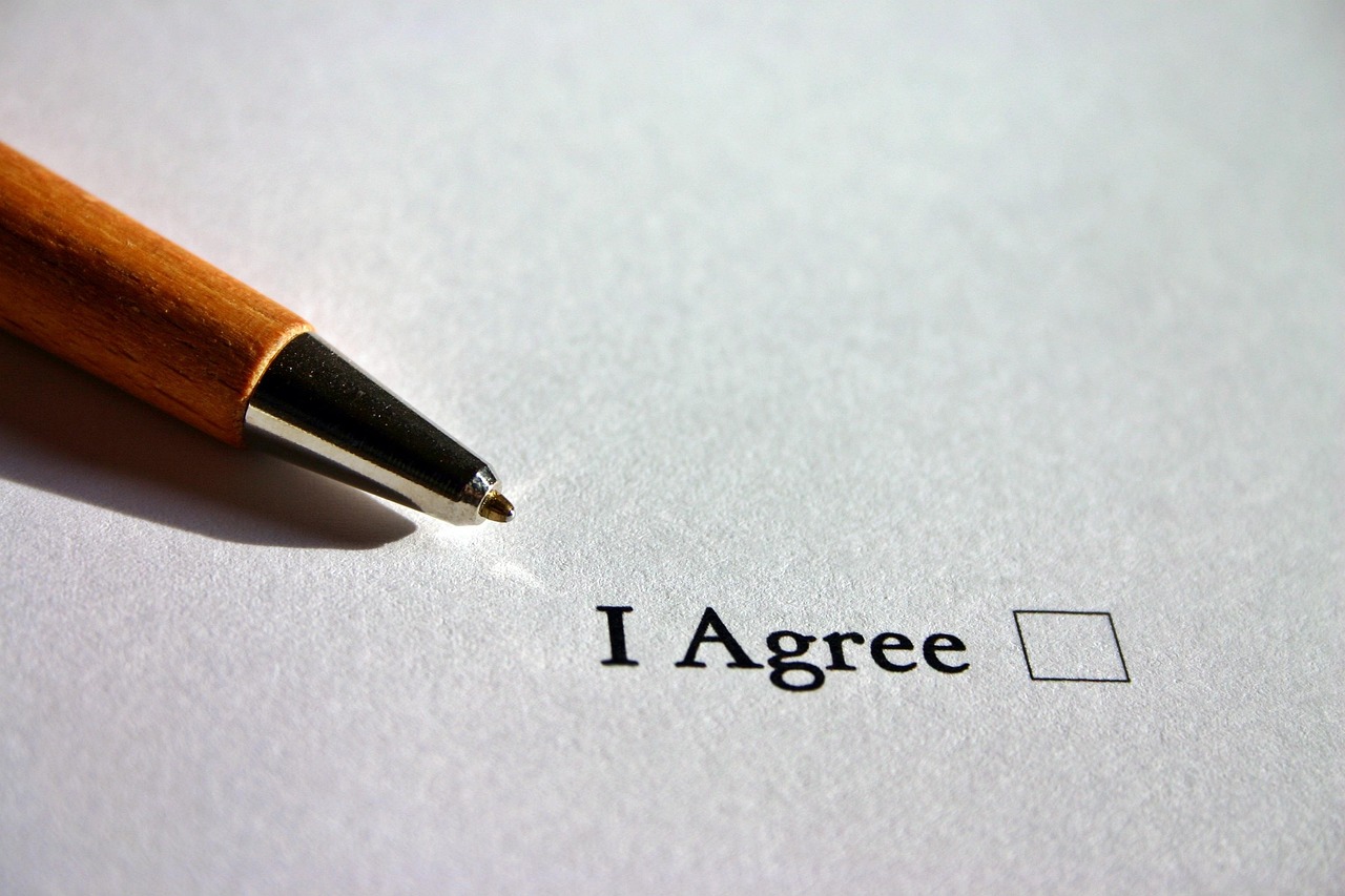 Legal business documents and a pen on a desk representing the KYC verification process.