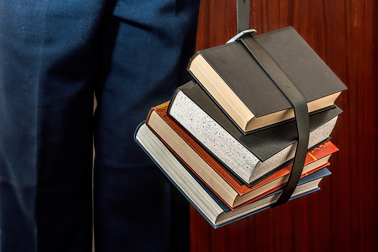 A student studying in a modern university library, representing academic goals.