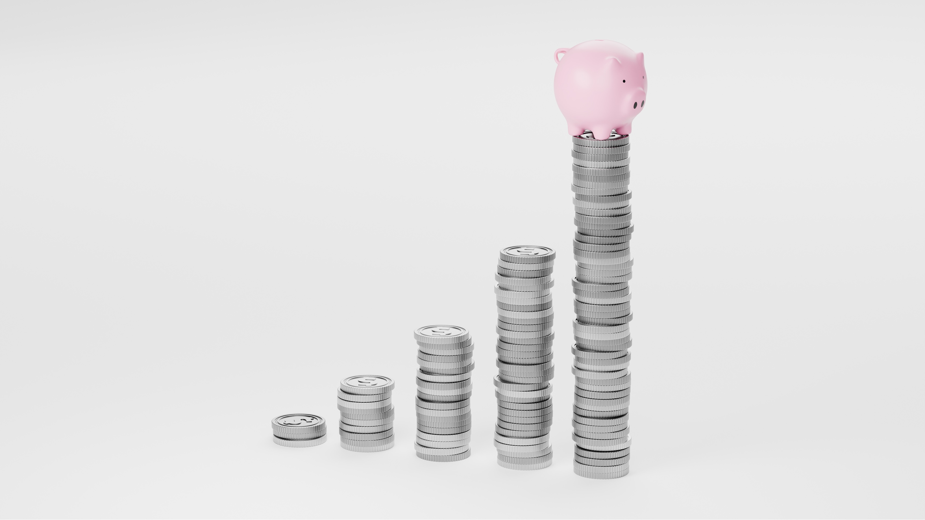 Increasing stacks of gold coins with a small piggy bank on the tallest stack to represent growing savings.