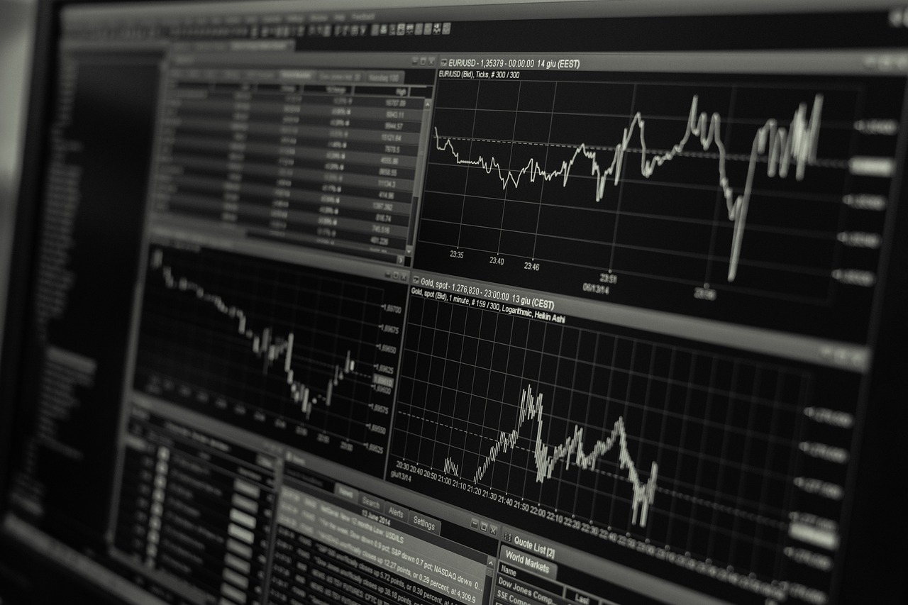 Stacks of gold bars next to a rising financial line graph