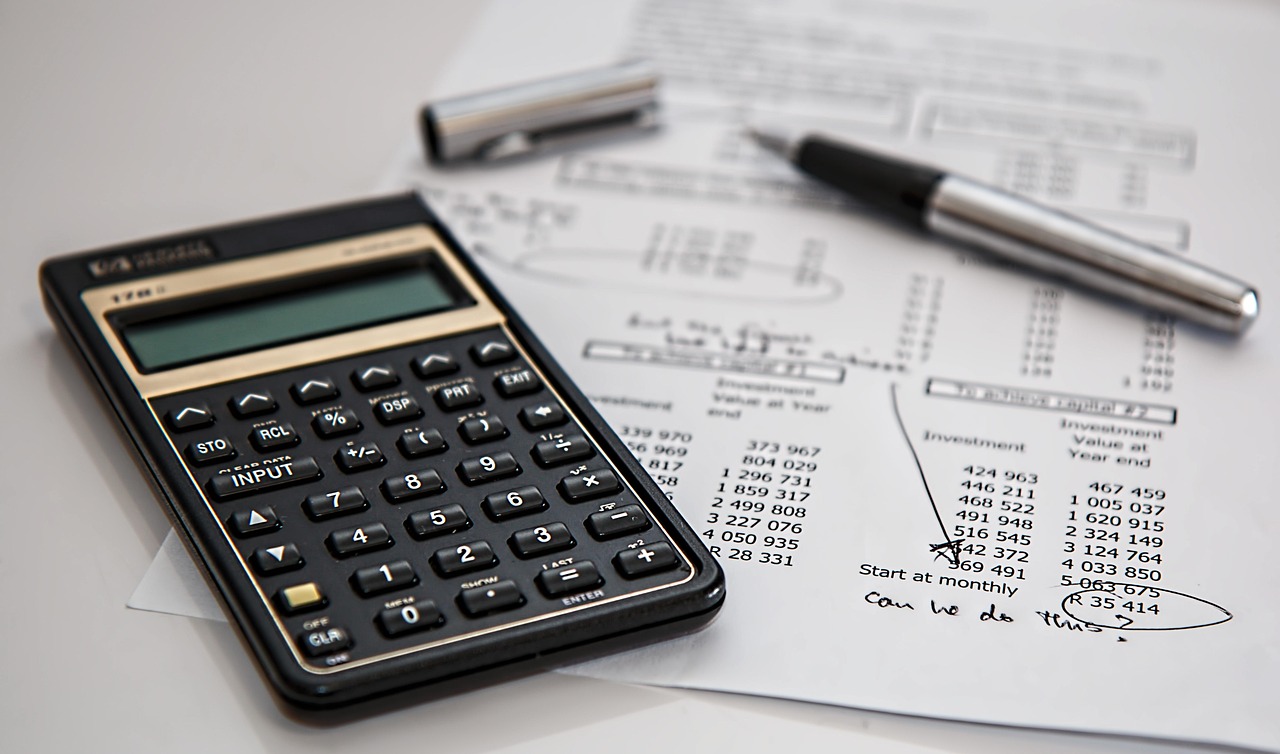 Financial documents and a pen on a desk, representing Schedule E tax reporting.