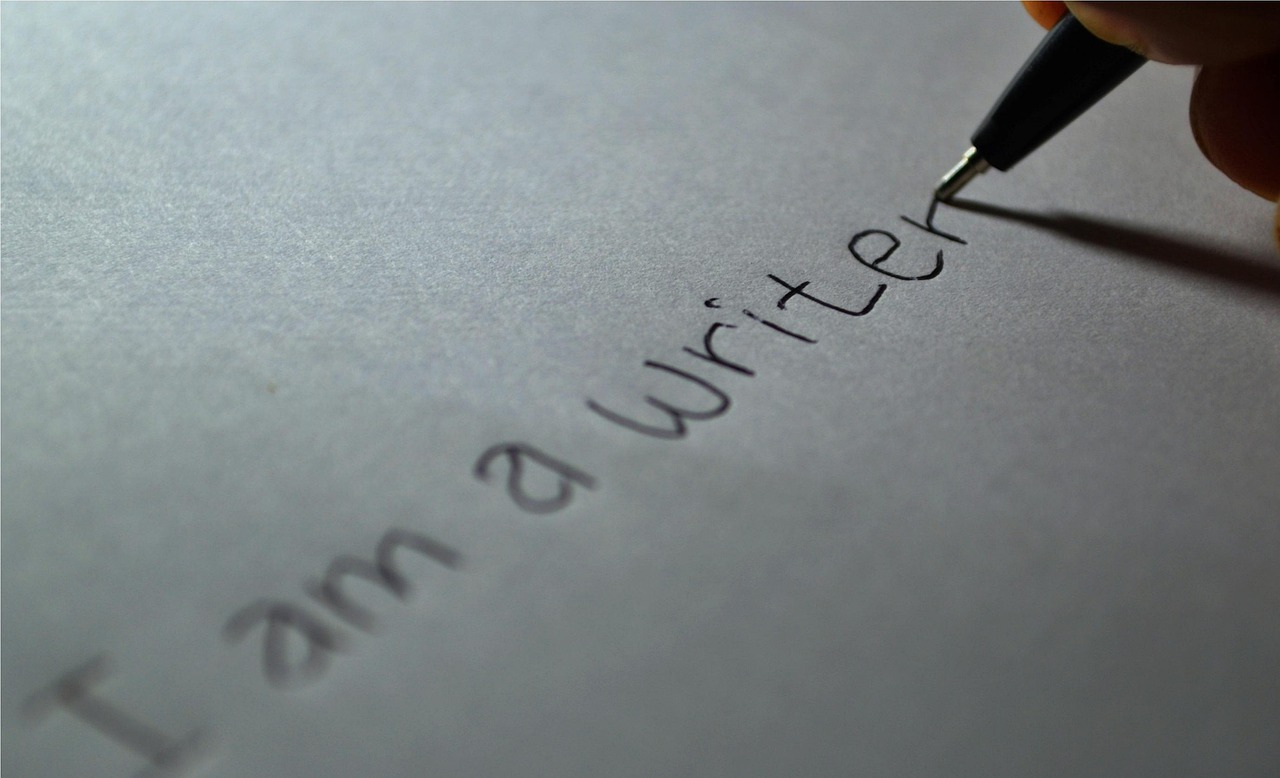 A person writing a sincere letter on stationary with a fountain pen.