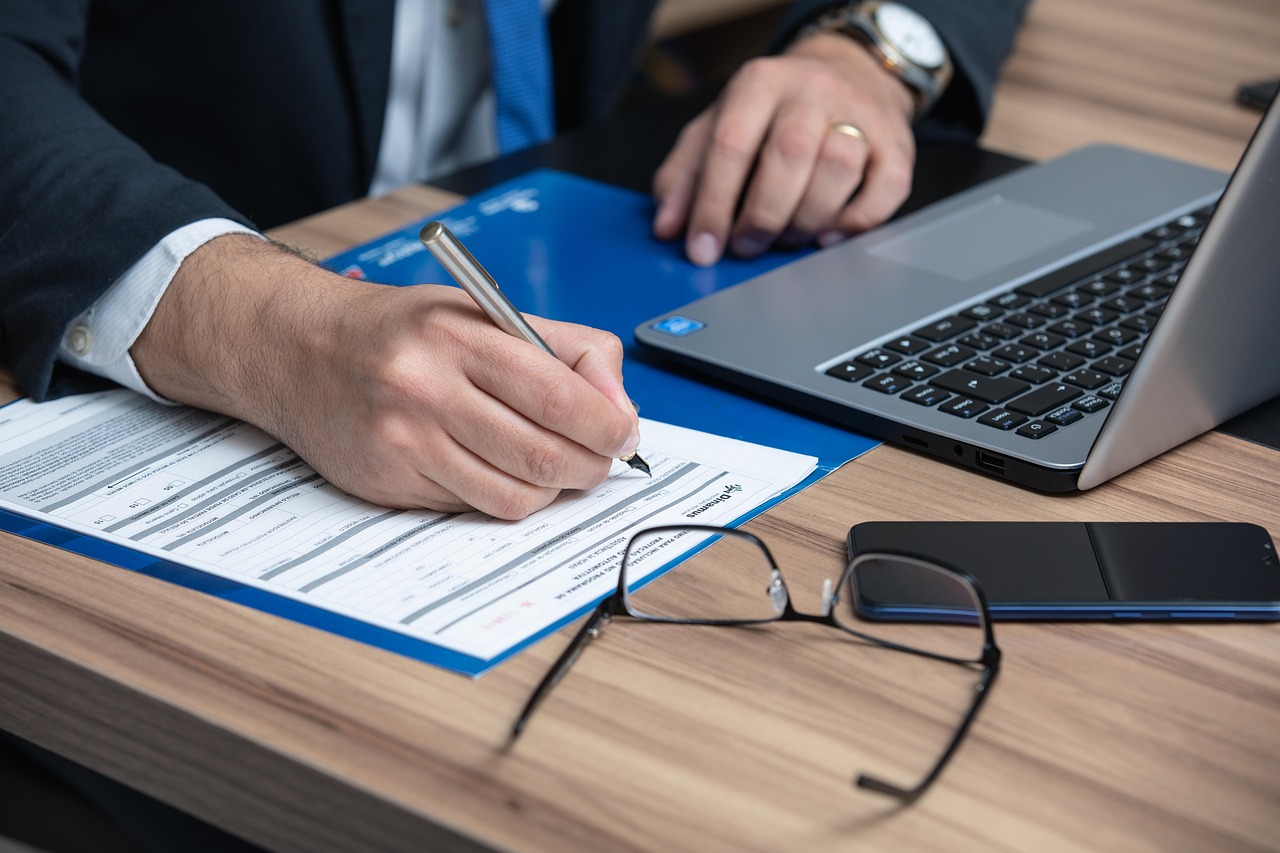 A person signing a legal document with a professional fountain pen