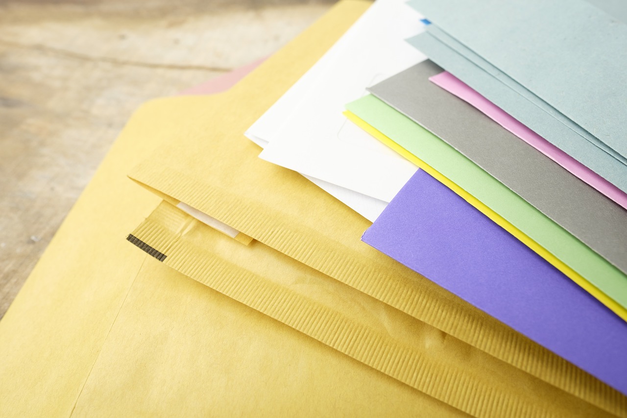 Financial documents and mail envelopes on a wooden desk