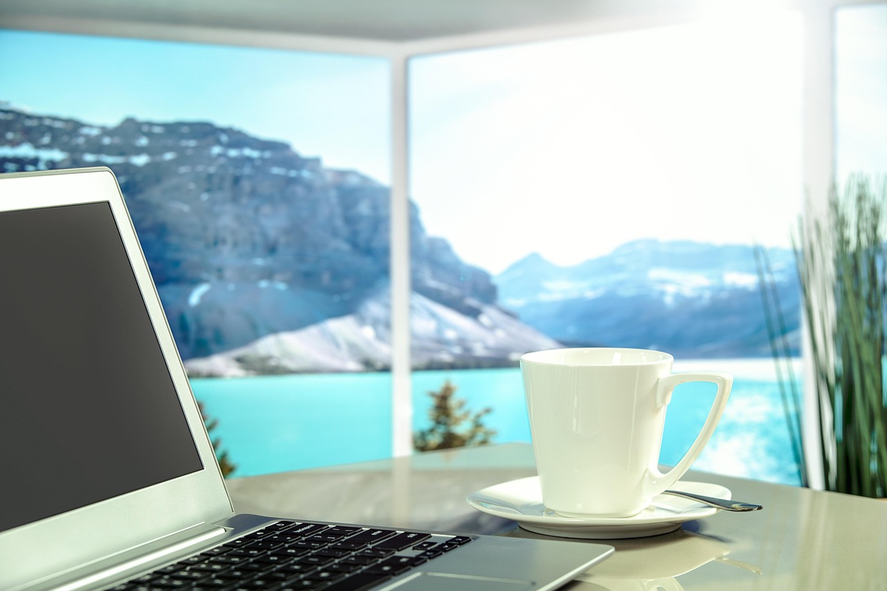 Professional working on a laptop on a terrace overlooking a foreign city