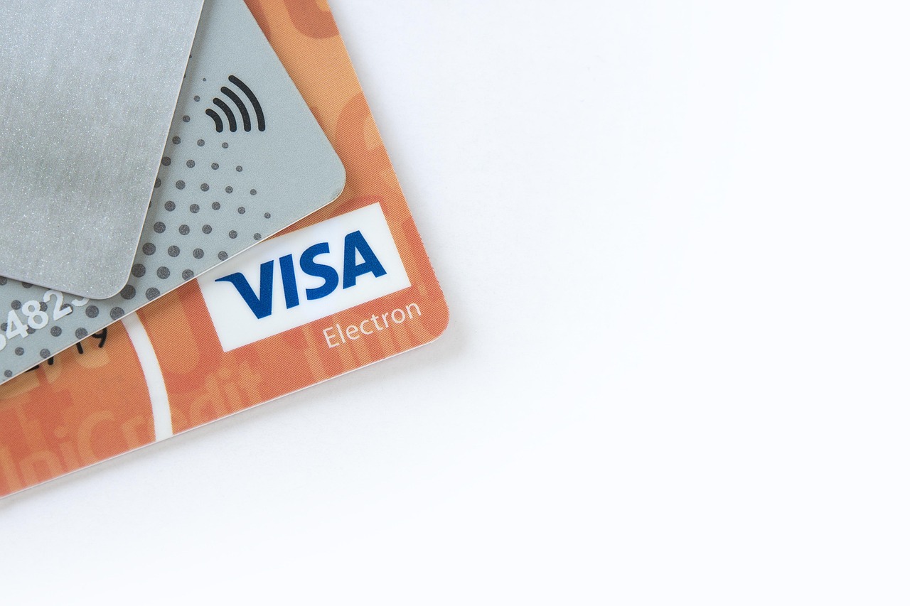 Various credit cards stacked neatly to symbolize a diverse financial portfolio.