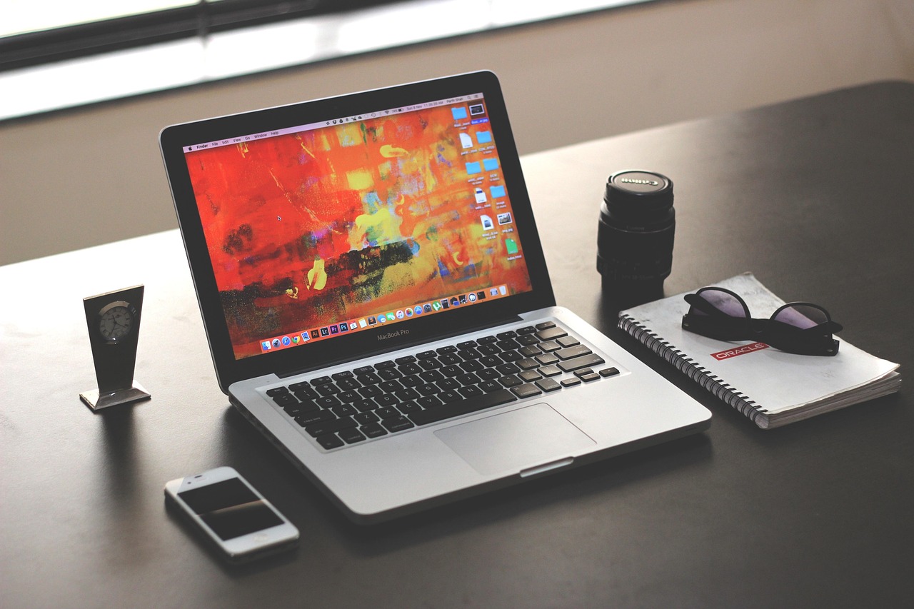 A hand typing on a laptop with a customer service chat bubble icon.