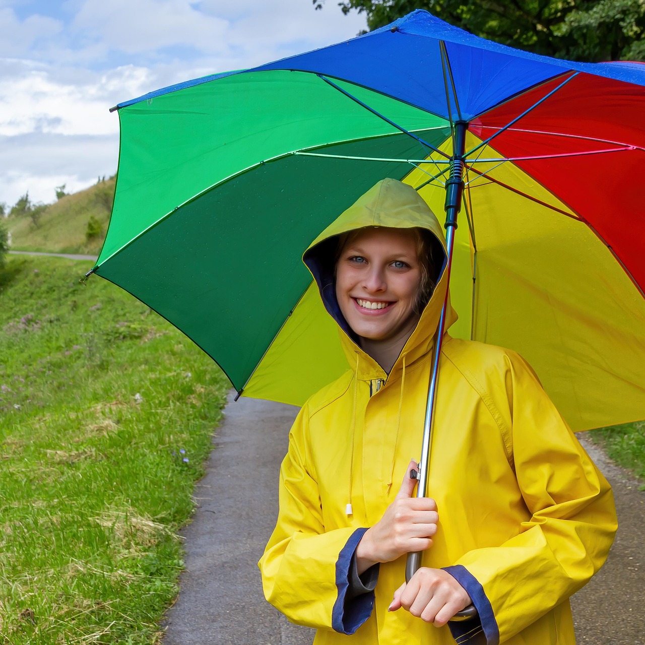 A sturdy umbrella protecting a stack of money from rain, symbolizing an emergency fund.