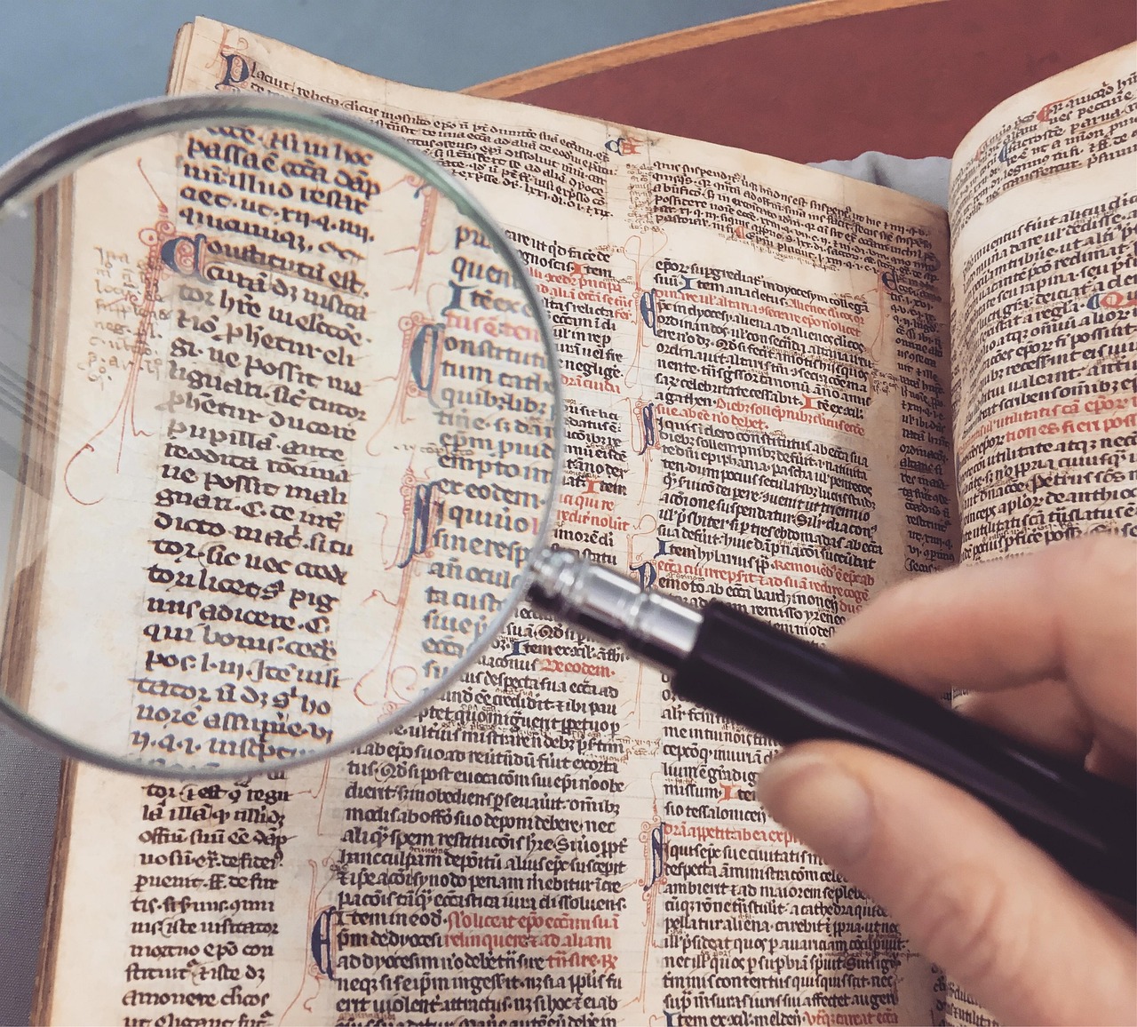 A magnifying glass hovering over complex legal text and fine print