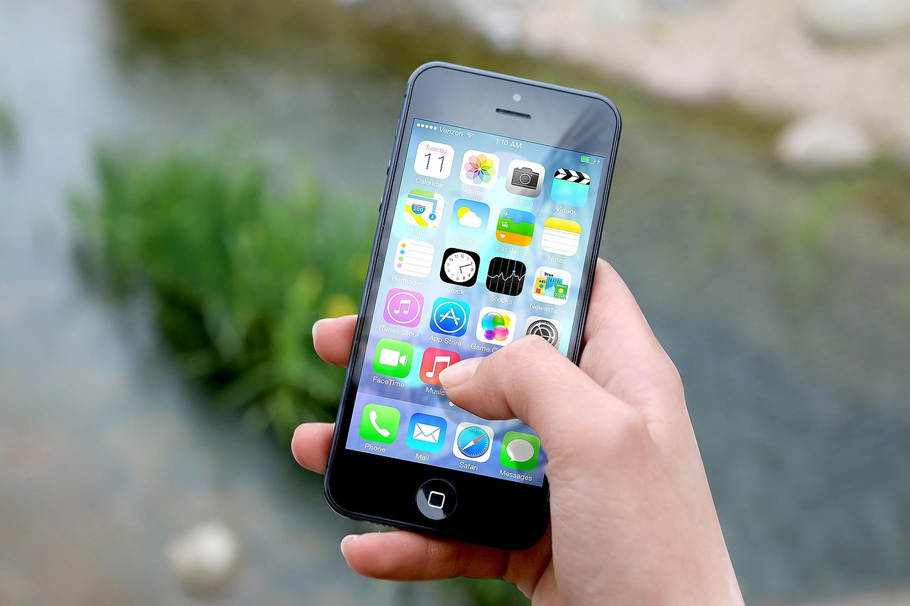 A hand holding a smartphone displaying a sleek financial banking application.
