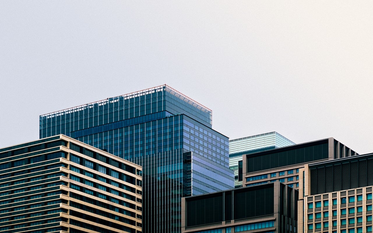 Close up of a professional handshake in a sunlit modern office space.