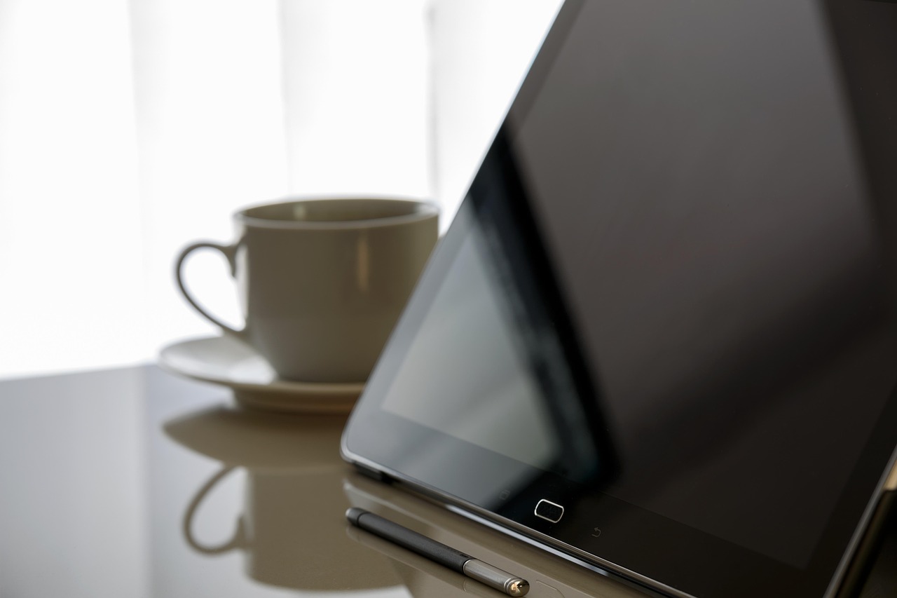 A person holding a tablet displaying complex financial data and ranking metrics.