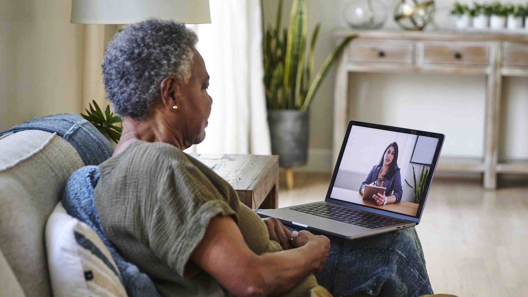 A remote worker attending a video meeting on her laptop with a stable connection.