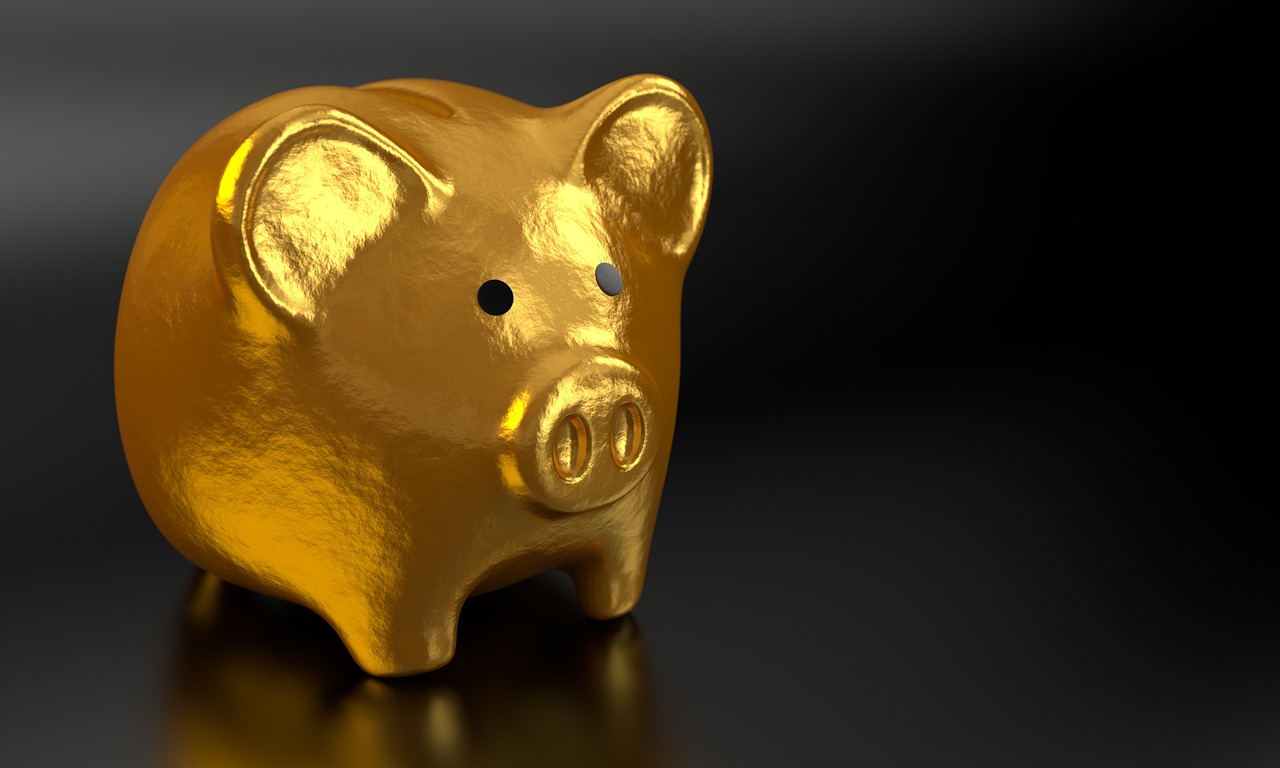 A small plant growing out of a jar of coins symbolizing retirement account growth